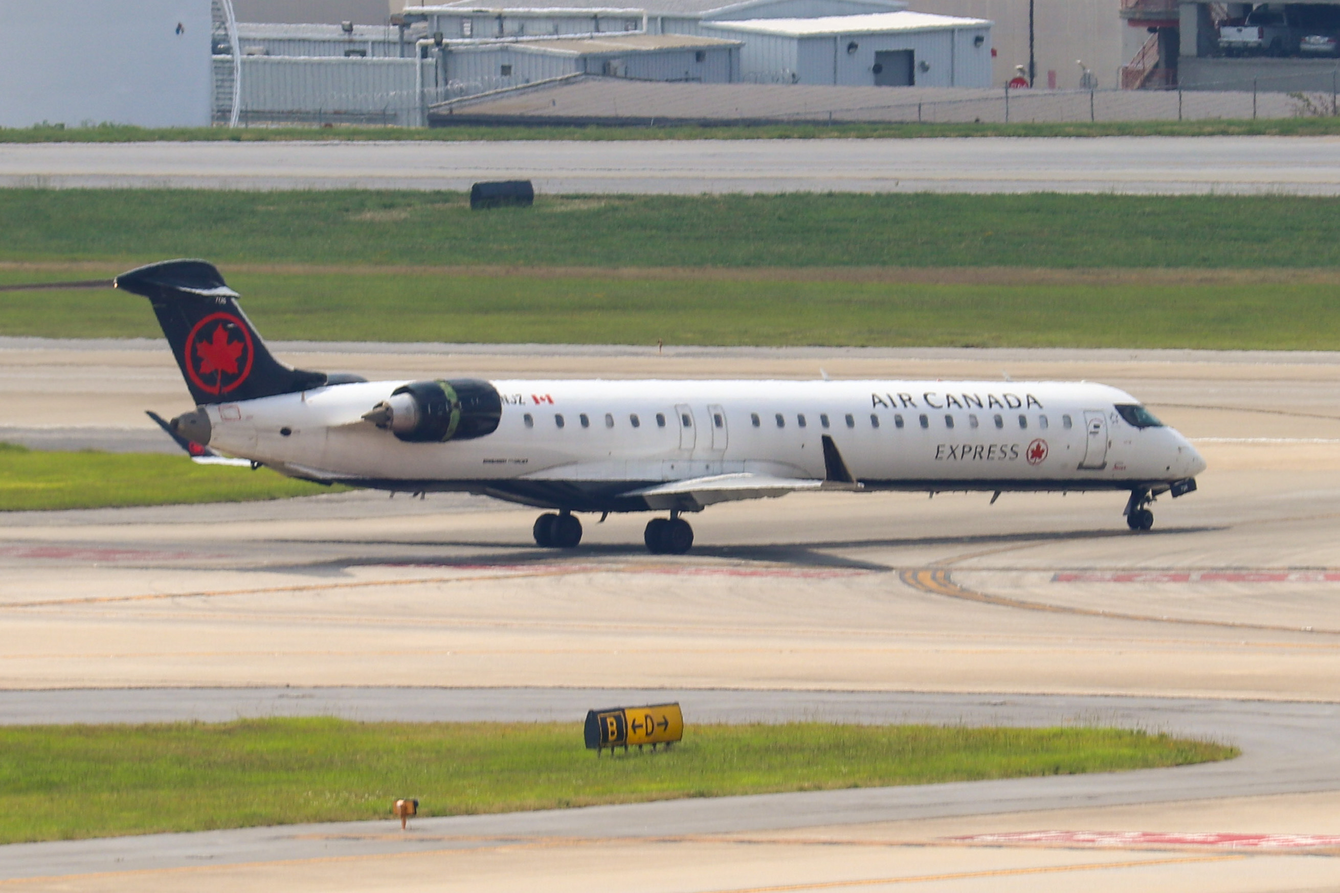 Air Canada Express CRJ-900 regional jet taxiing at an airport